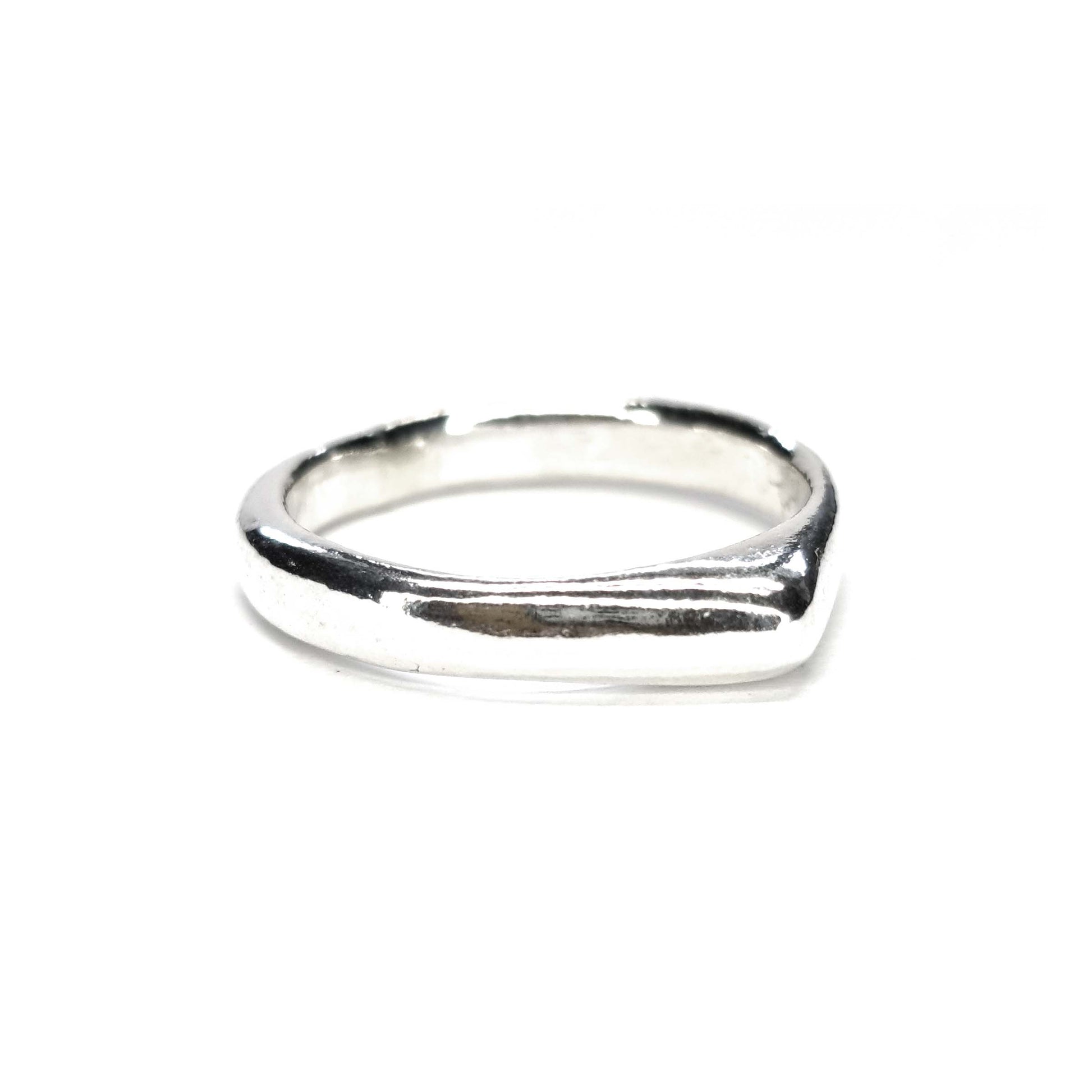 A silver ring which comes to a soft point at the top.