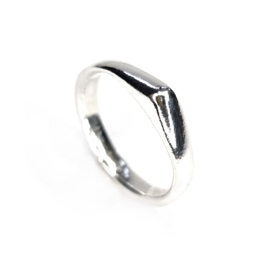 A silver ring which comes to a soft point at the top.