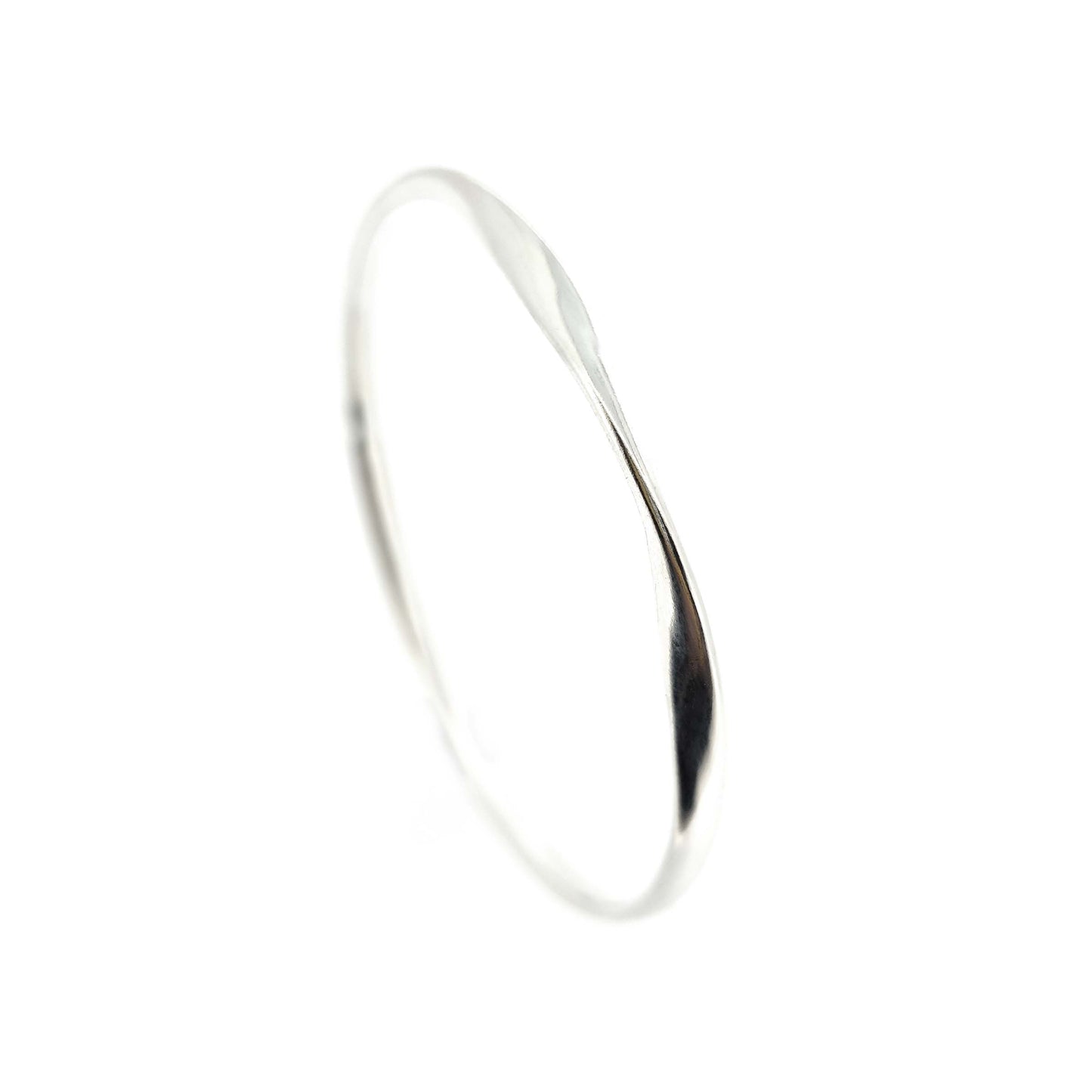 Round silver bangle with oval profile and a twist in one part.