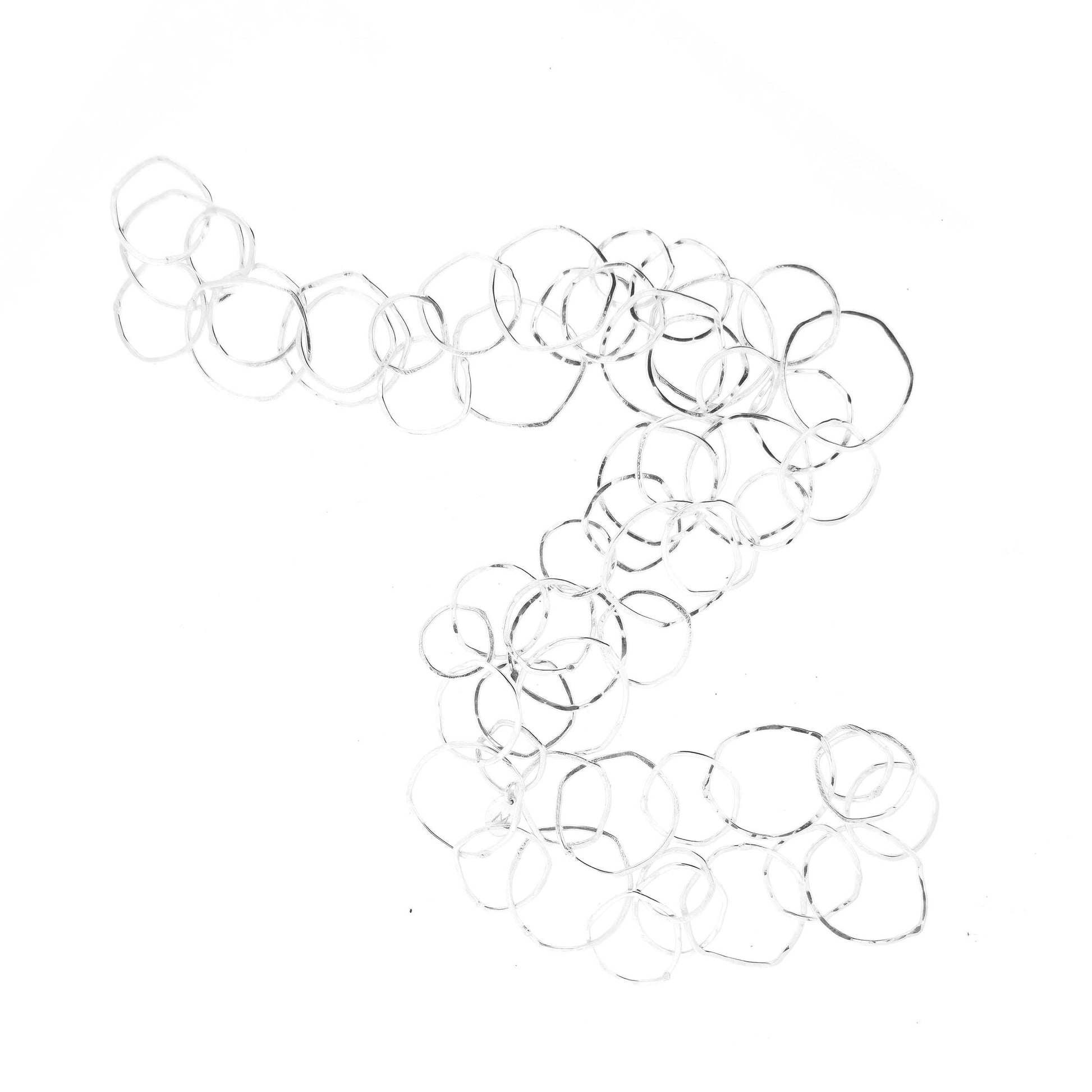 Silver necklace with rustic interlocking circular links on a white back ground