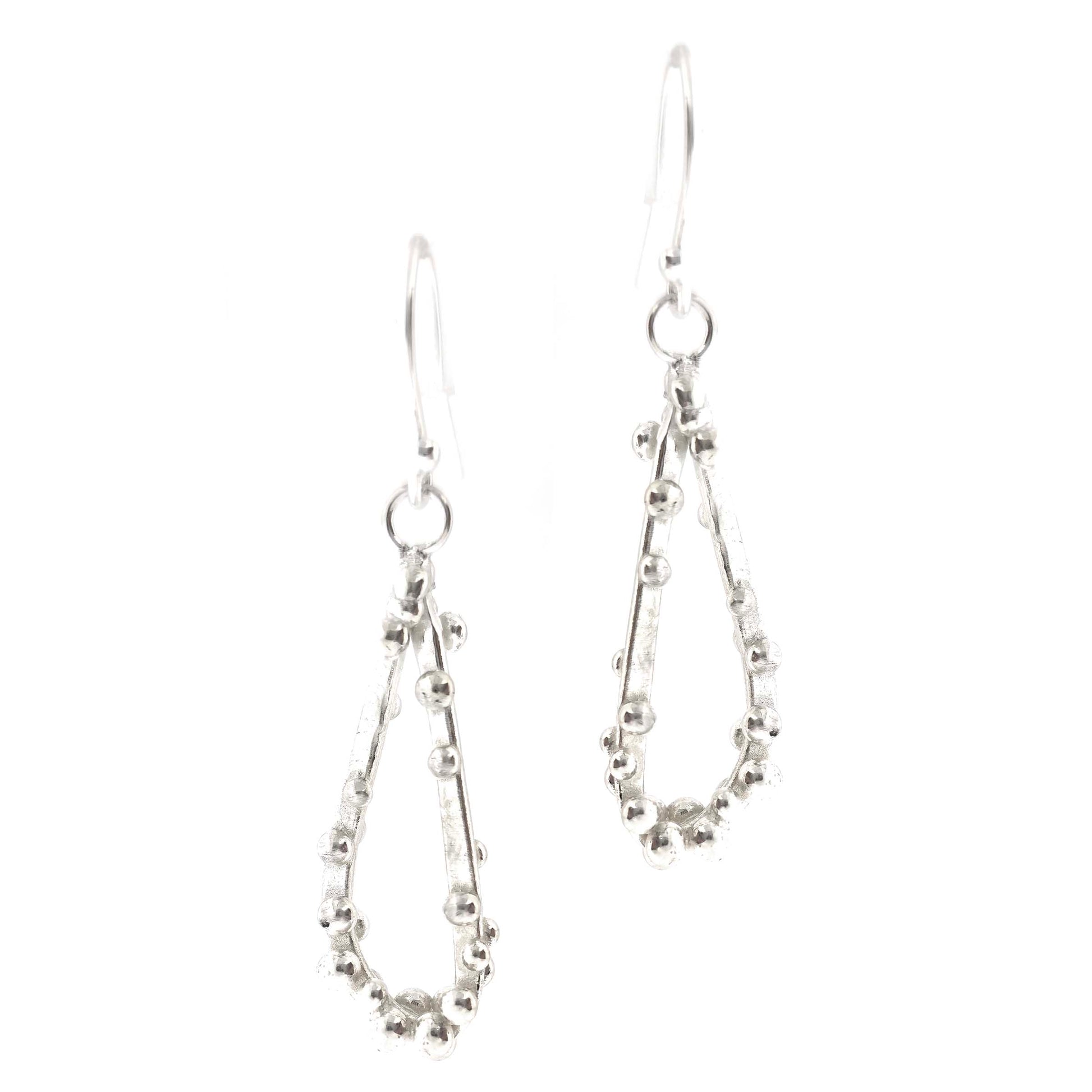 Silver drop earrings in a asymmetrical open teardrop shape with silver balls. S.own on a white background.
