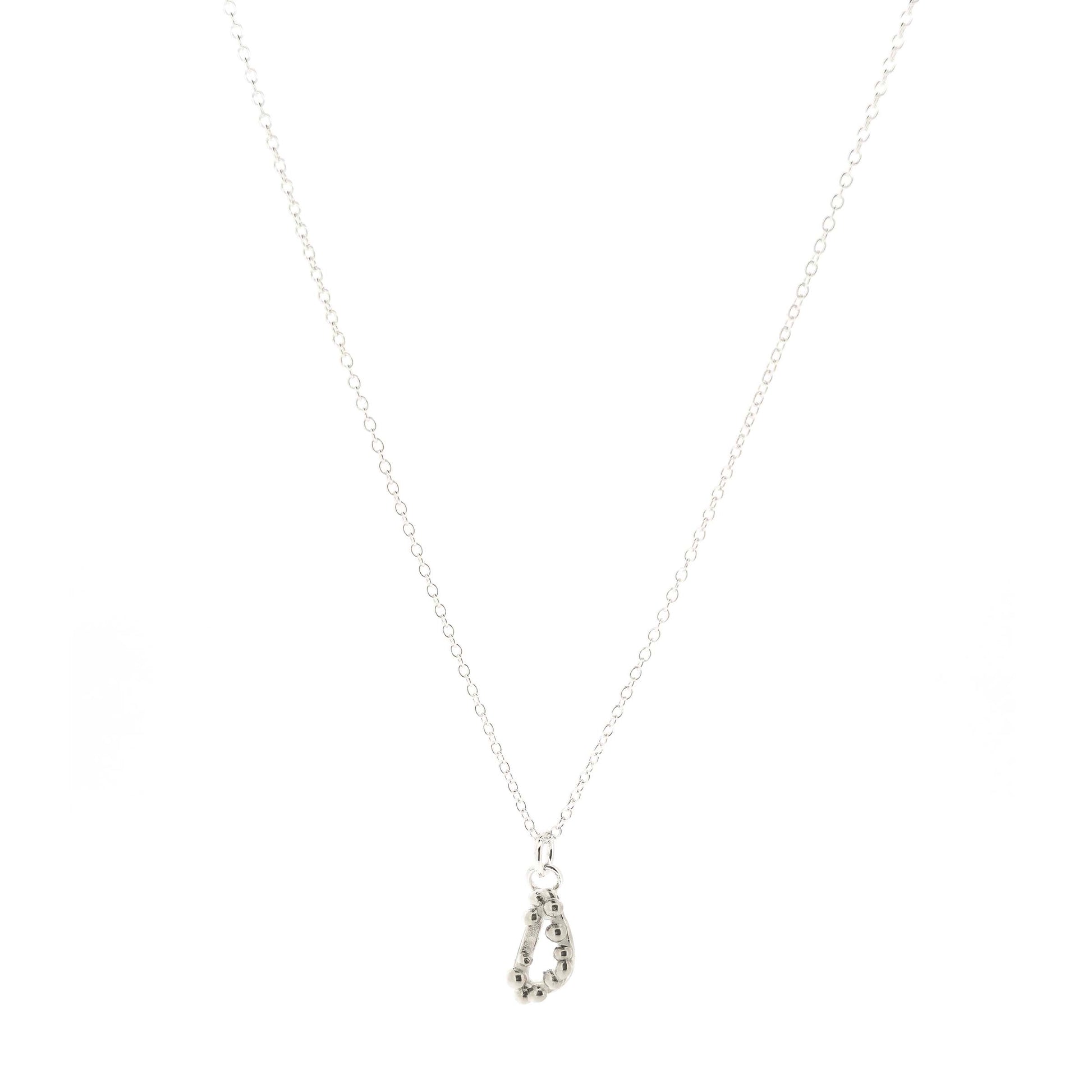 Silver asymmetric open triangle pendant with silver balls on a silver chain. Shown on a white background.