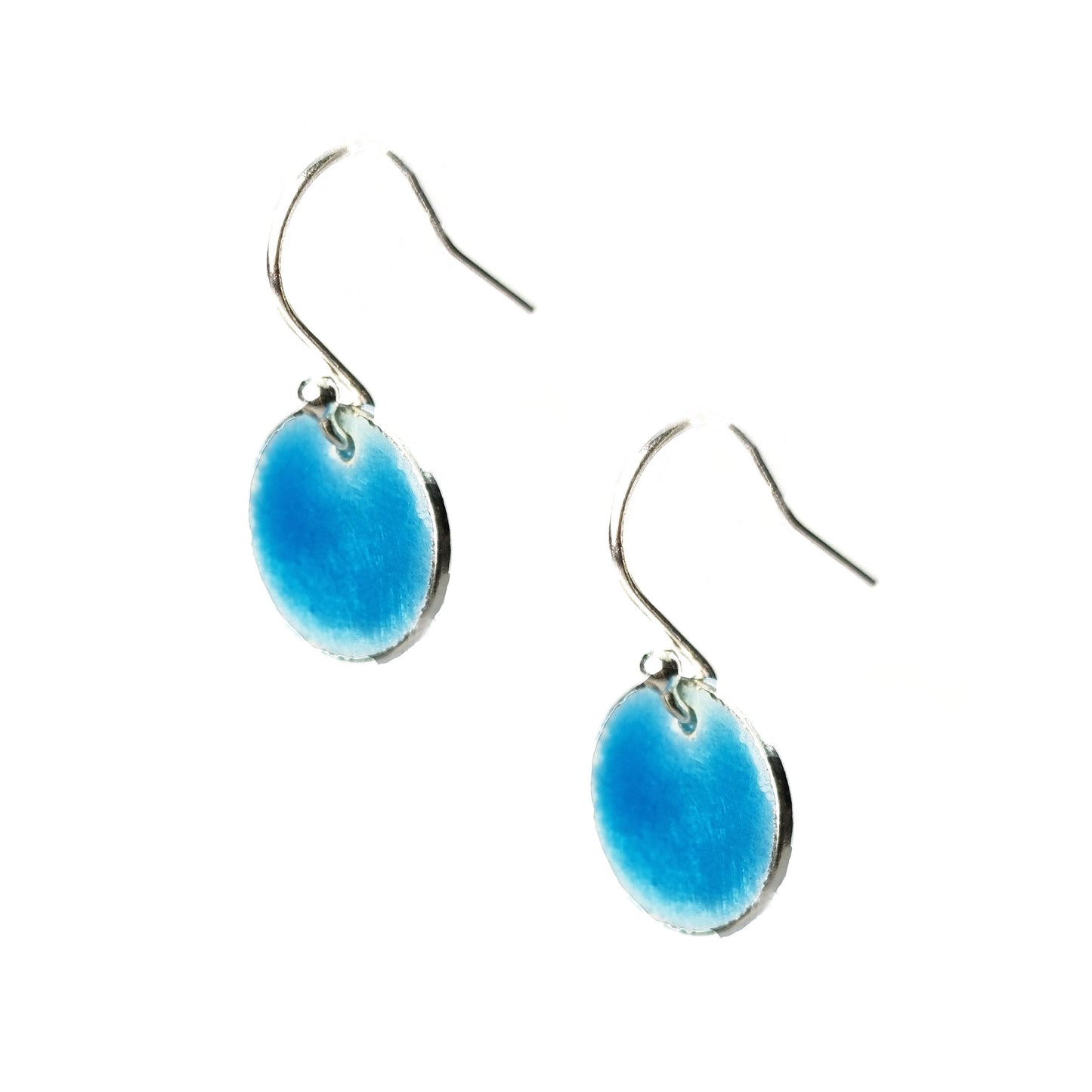 Silver drop earrings with a round disc covered in turquoise blue enamel.