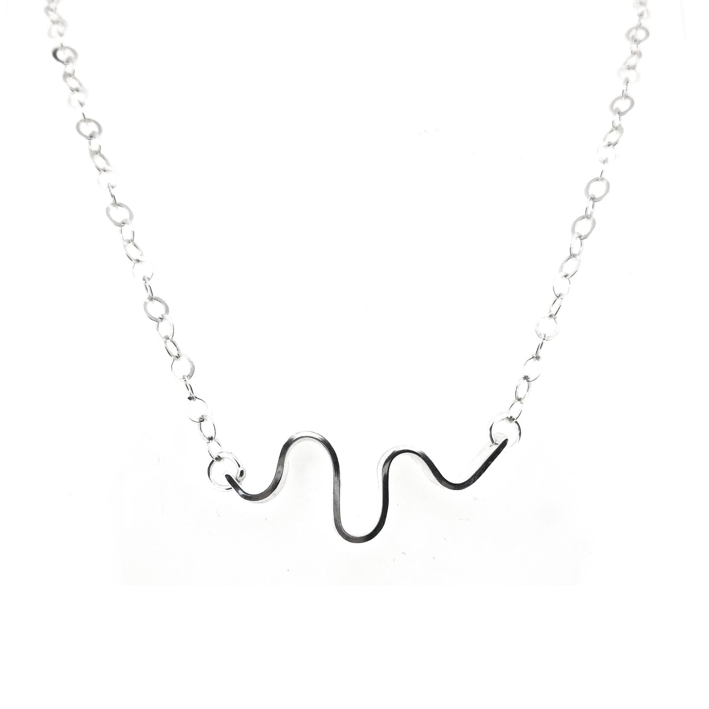 A silver necklace with an open chain and a wave of silver at the center.
