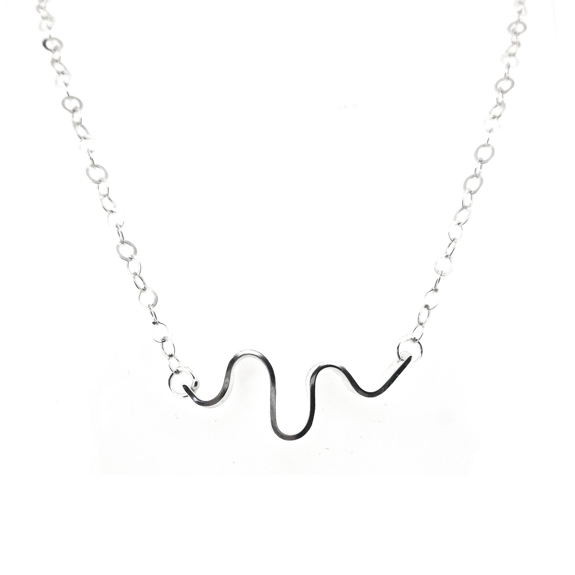 A silver necklace with an open chain and a wave of silver at the center.