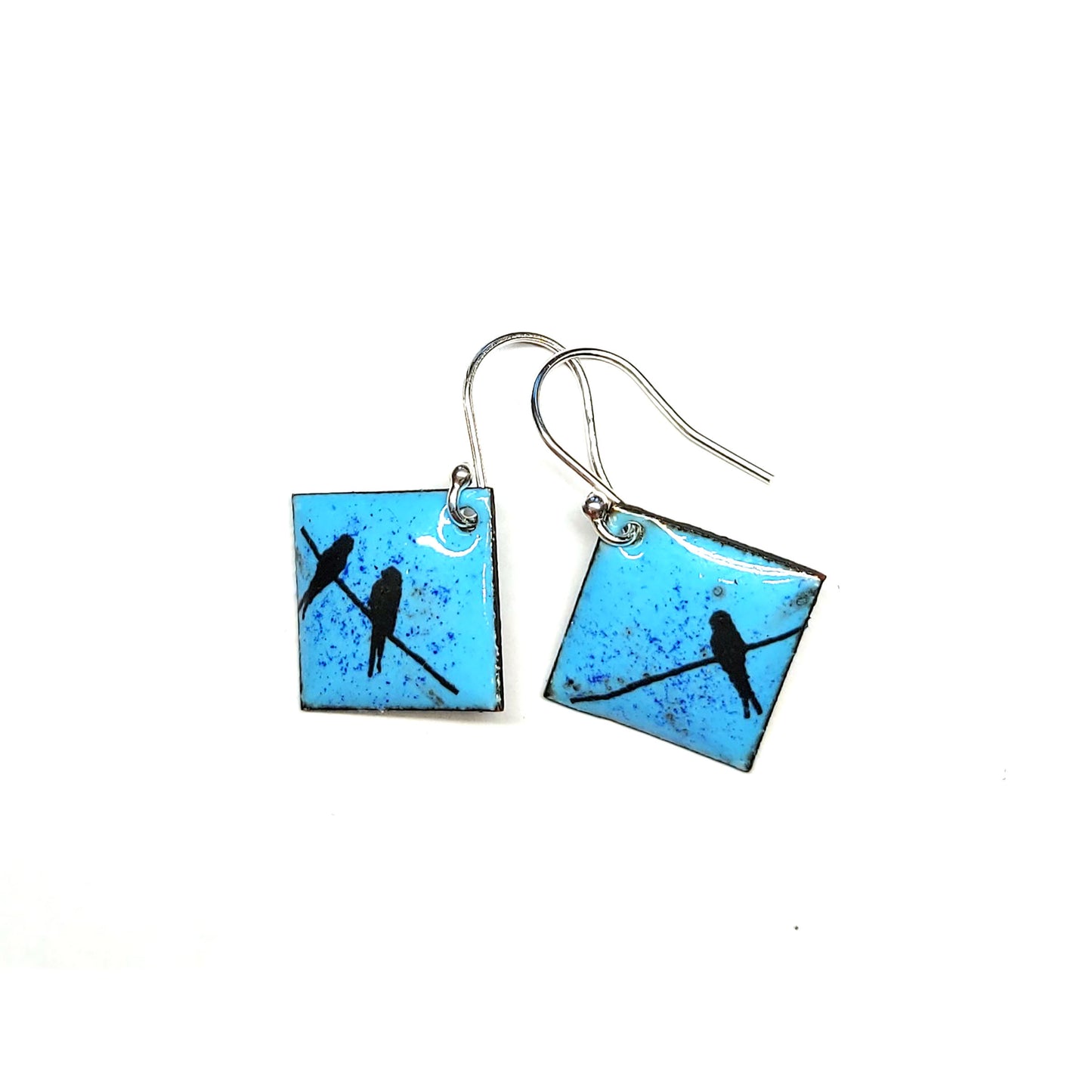 Square drop earrings featuring silhouettes of birds sitting on a wire against a blue enamel background.