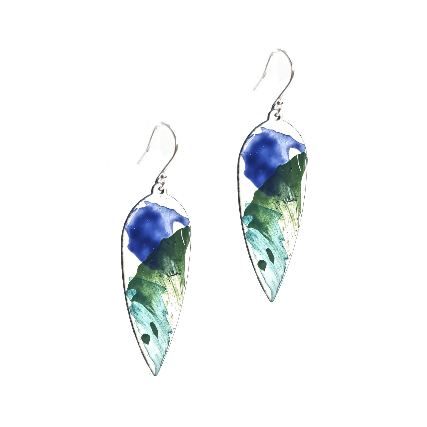 Large teardrop-shaped enamel drop earrings with splashes of dark blue and green on a white background
