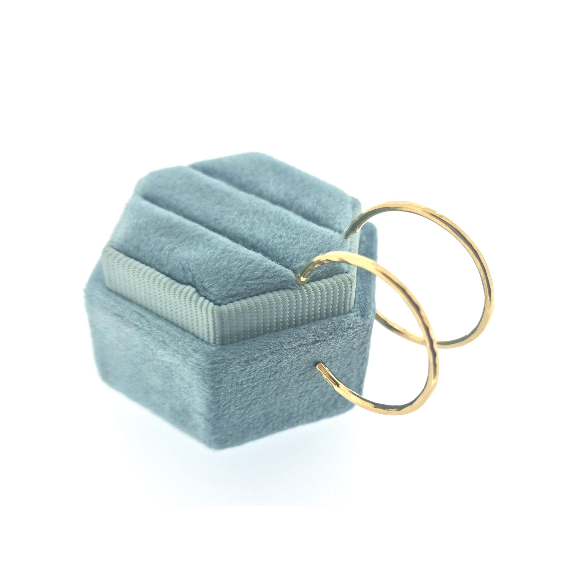 Yellow gold vermeil thin hammered hoop earrings, large. Pictured on a jewellery box.