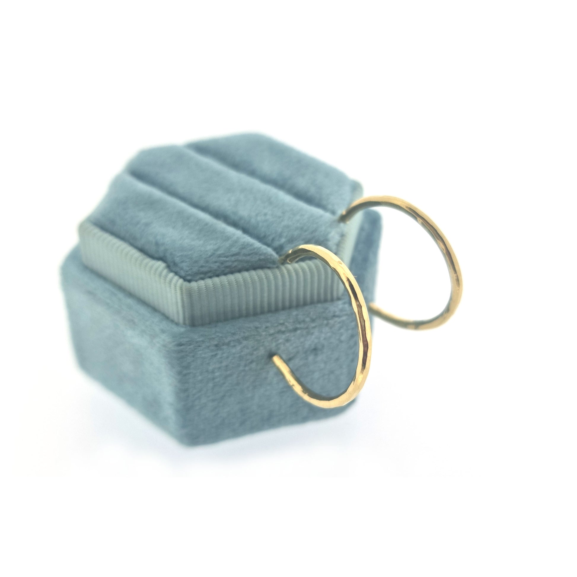Yellow gold vermeil thin hammered hoop earrings, medium. Pictured on a jewellery box.