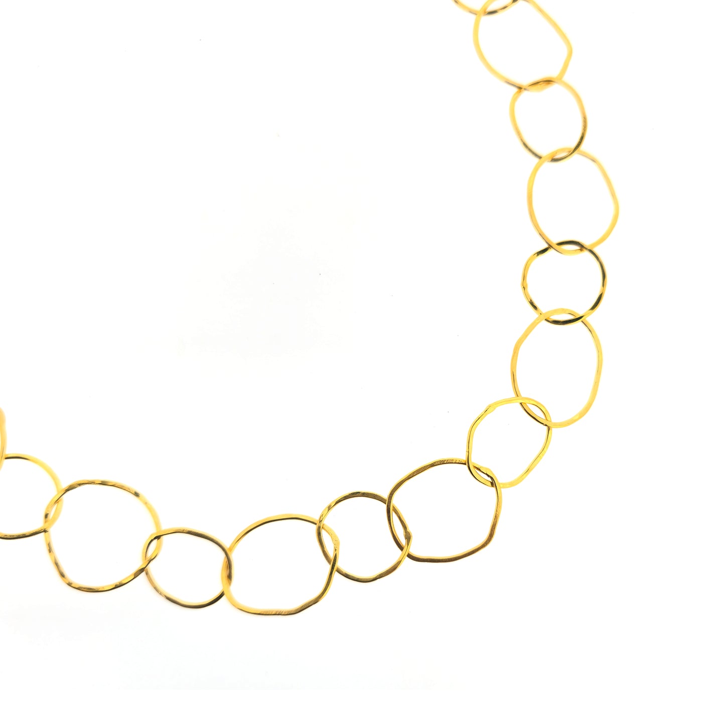 A yellow gold vermeil chain necklace with organic style circular links.