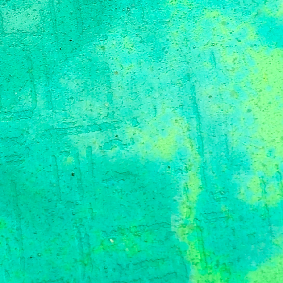 A close-up of a textured surface with a mottled turquoise and light green pattern. Handmade. Mijoux Jewellery.