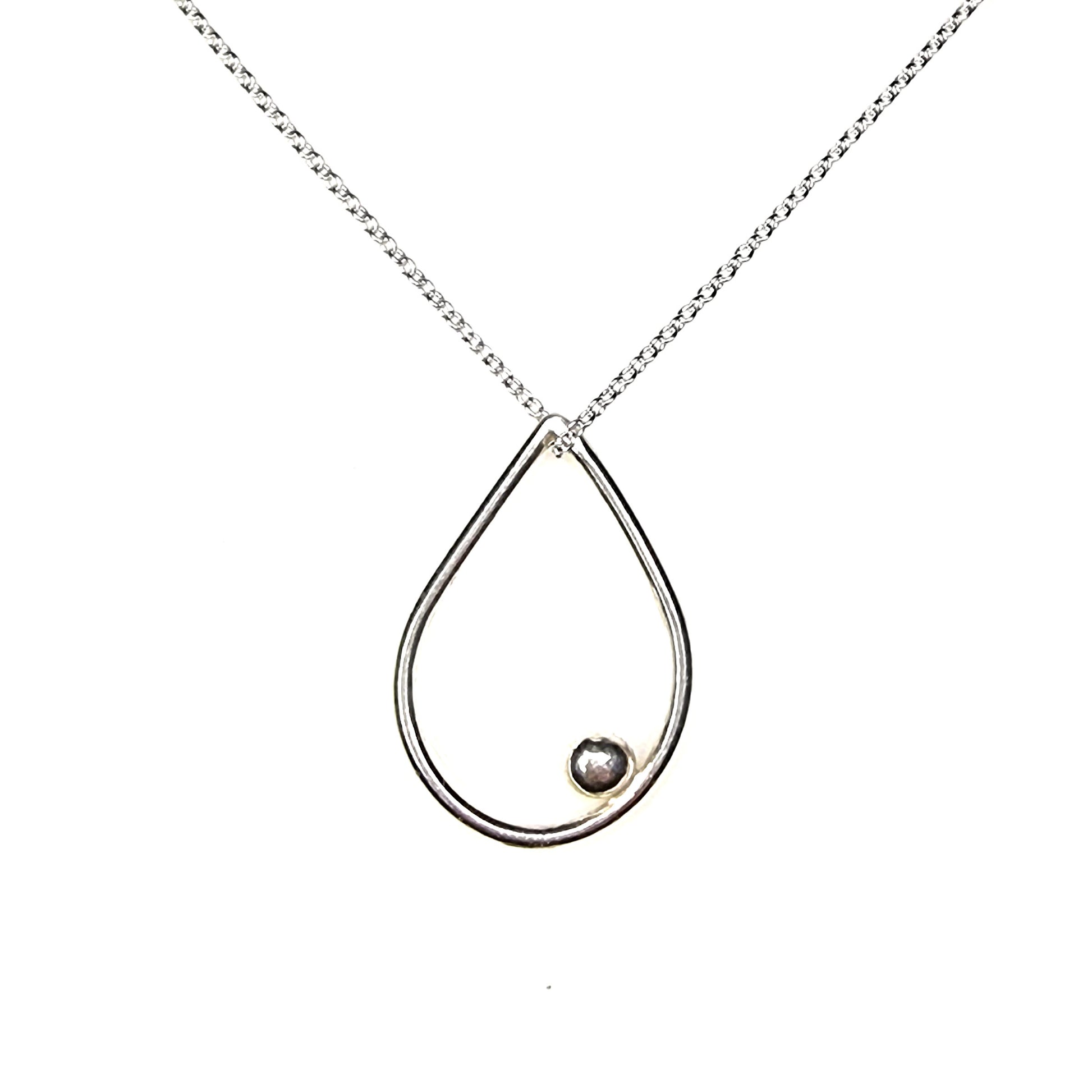 A silver open teardrop shaped pendant with an off-centre ball. On a silver chain. Large.