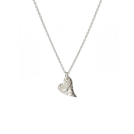A silver asymmetrical heart pendant with a leaf and vine pattern suspended on a silver chain. - small