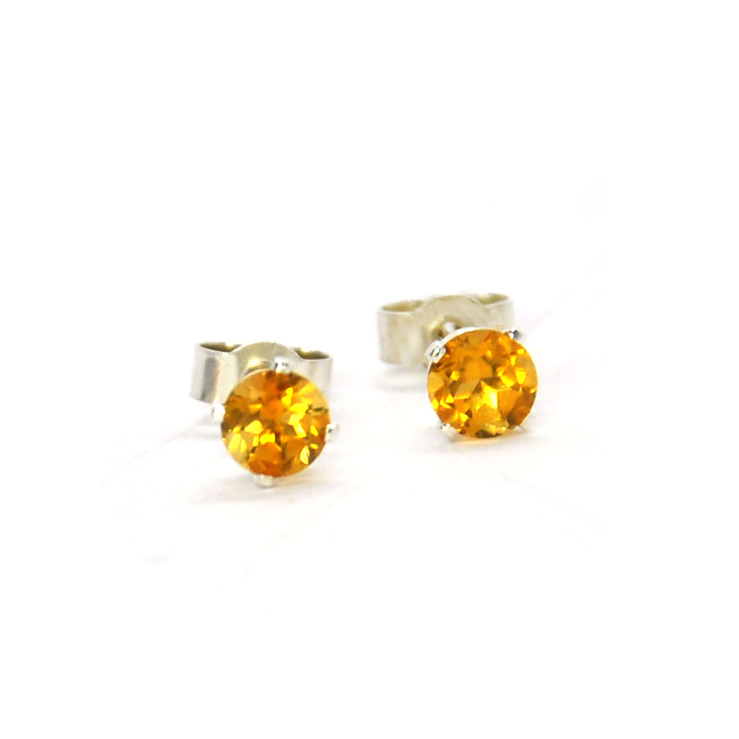 Silver 4 claw stud earrings with golden yellow citrine gemstones.