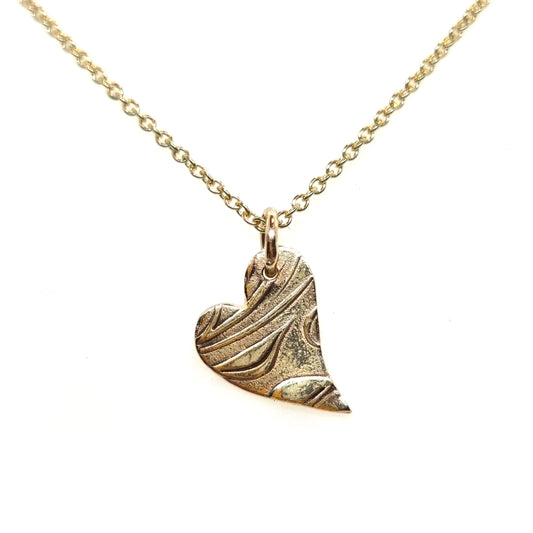 9ct yellow gold patterned asymmetrical heart pendant on chain.