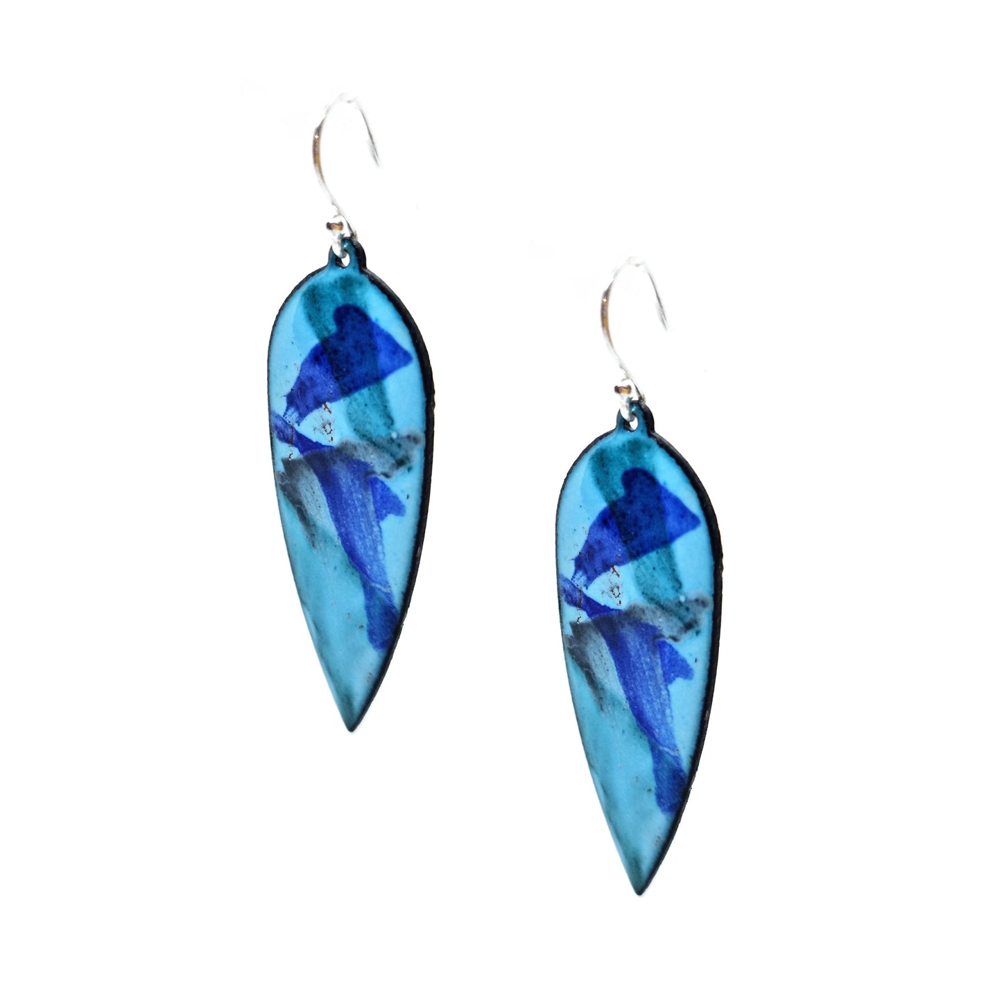 Large teardrop shaped enamel drop earrings with splashes of dark blue, red, green and grey on a light blue background