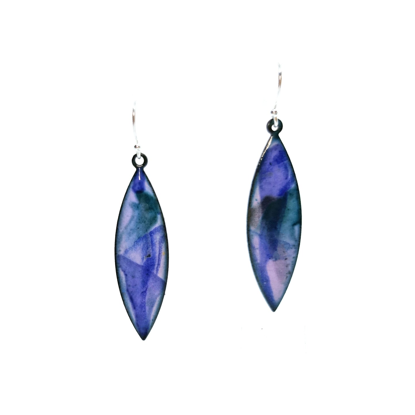 Boat-shaped enamel drop earrings with splashes of blue, green and grey on a light purple background