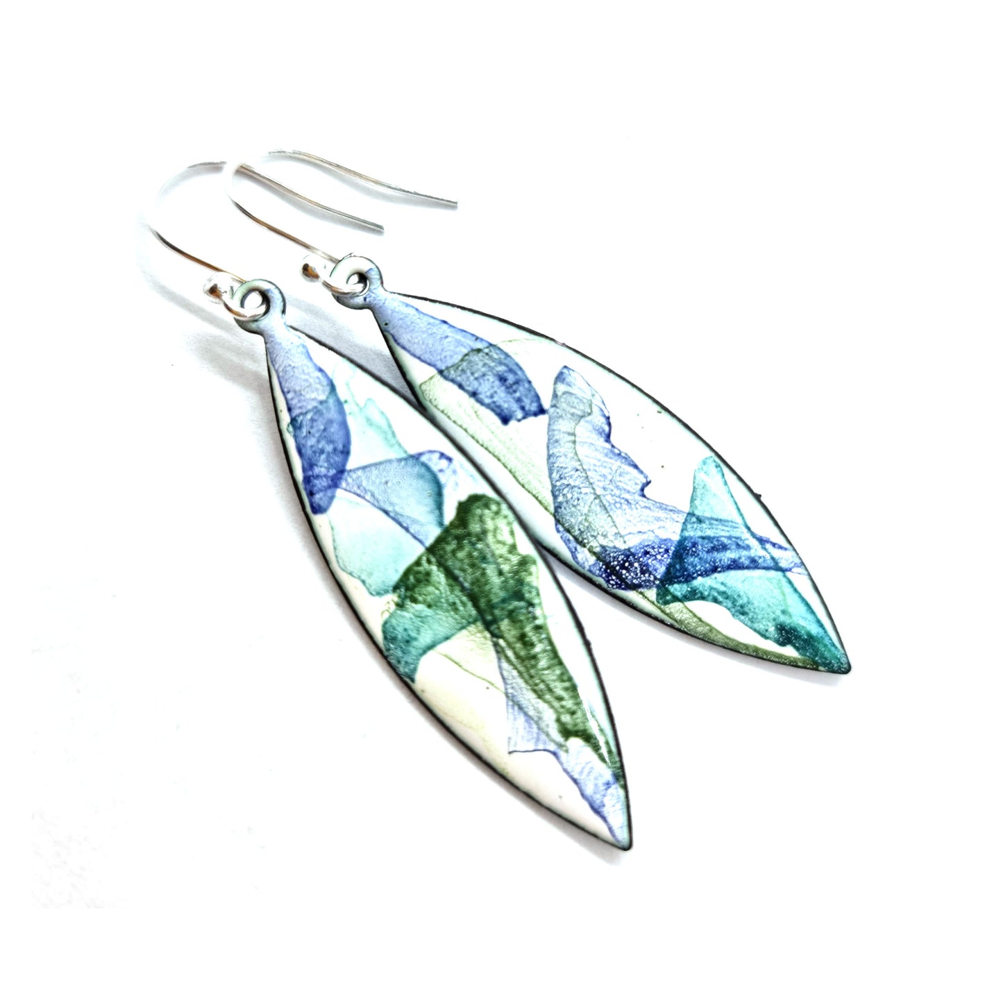 Navette shaped enamel drop earrings with splashes of green and blue on a white background