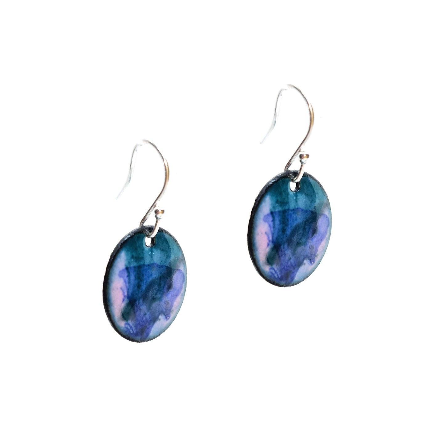 Round enamel drop earrings with splashes of dark blue, green and grey on a light purple background