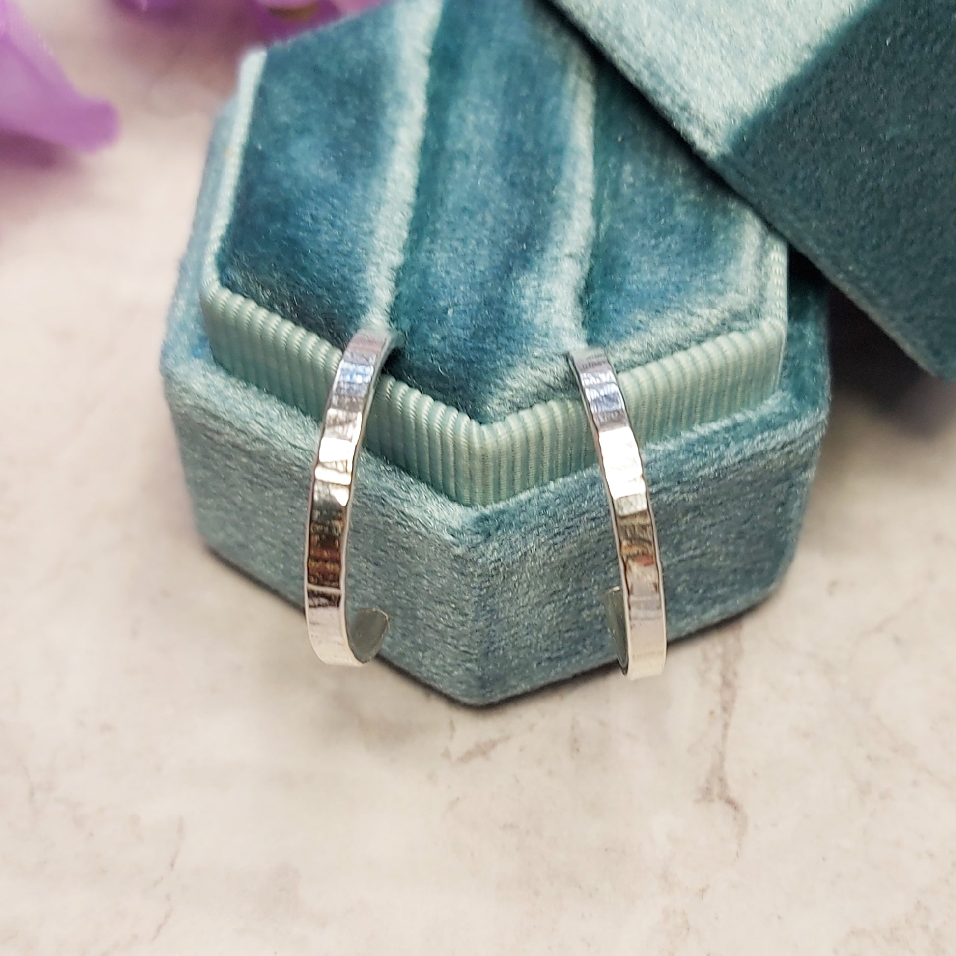 Silver flat hoop earrings with line texture in jewellery box