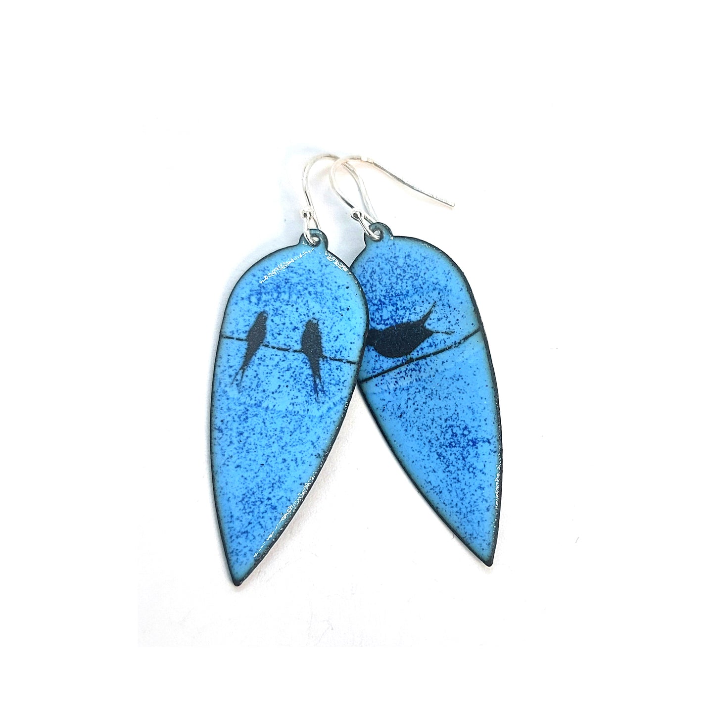 Large teardrop-shaped enamel drop earrings with black silhouettes of birds sitting on a wire against a blue background