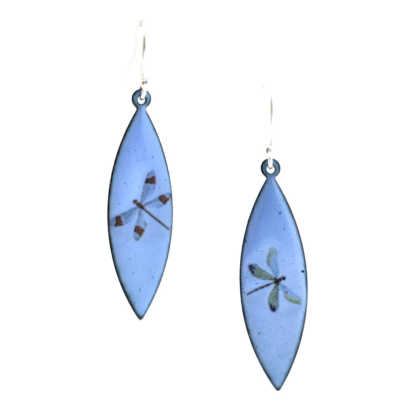 A pair of enamel earrings with different coloured dragonflies on a pale blue background. On silver ear hooks.