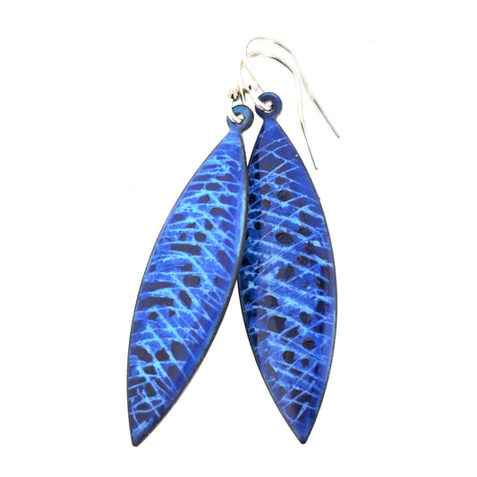 A pair of handmade enamel earrings with lines of light blue and sections of dark blue. On sterling silver ear hooks. Mijoux Jewellery.