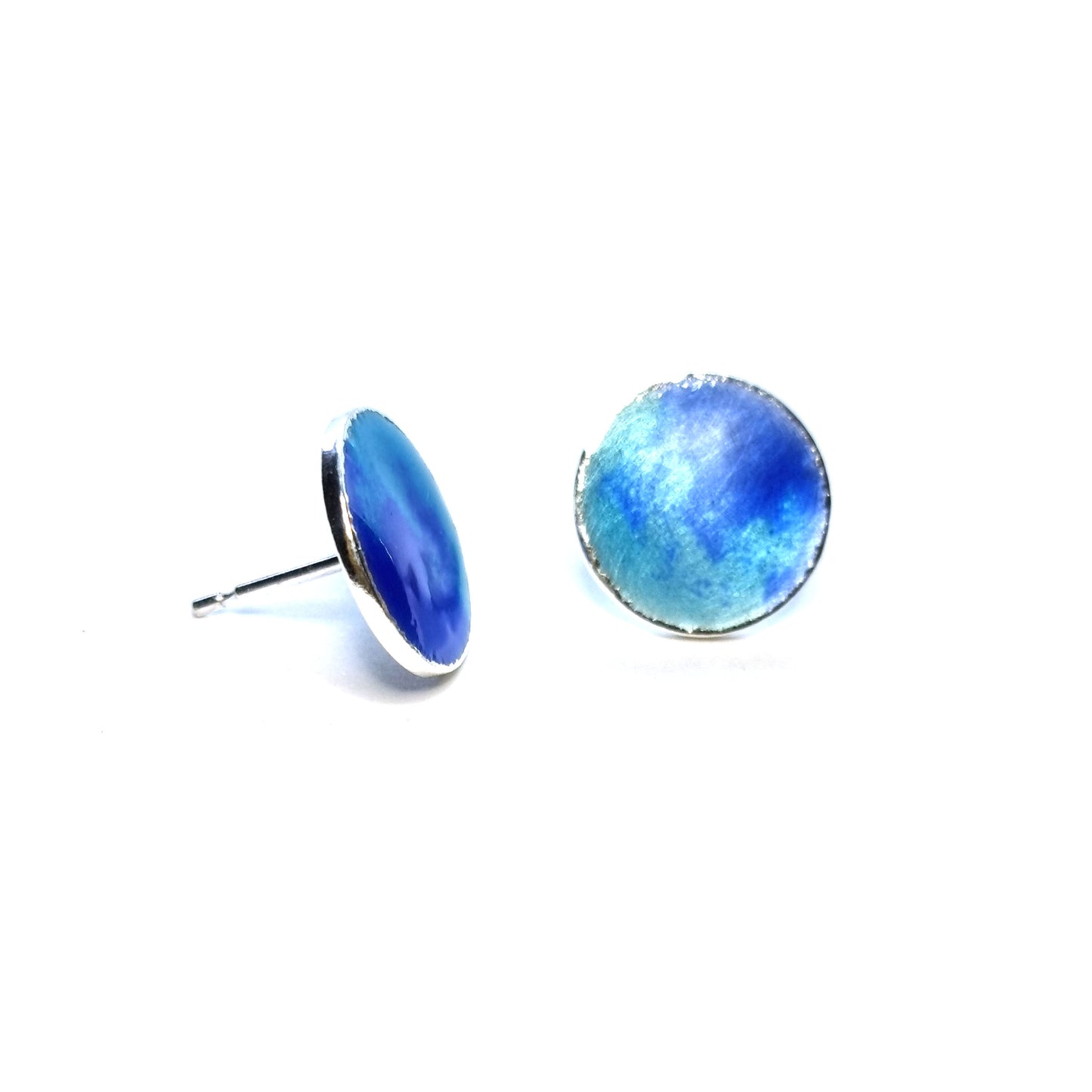 Round silver stud earrings with a mix of blue enamels.