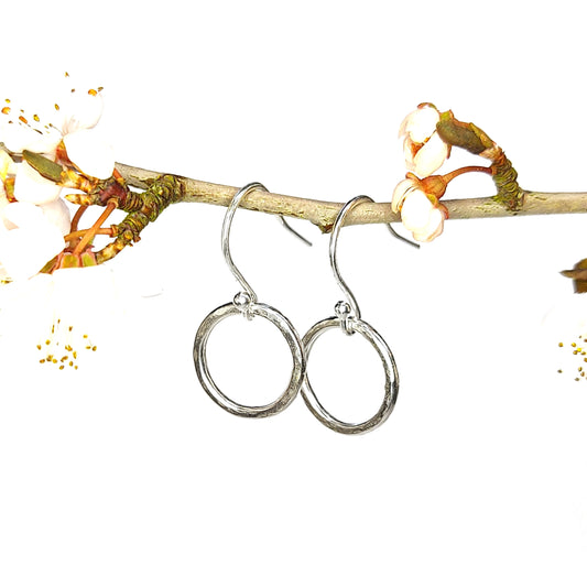 Sterling silver open circle drop earrings with hammered finish - small. Suspended from cherry blossom branch
