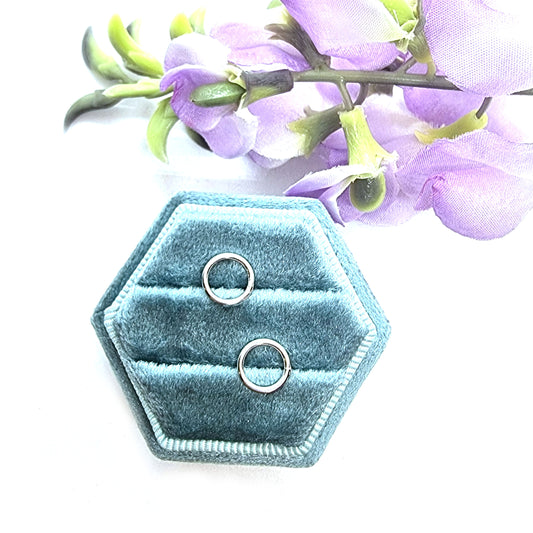Sterling silver open circle stud earrings in jewellery box with flowers.