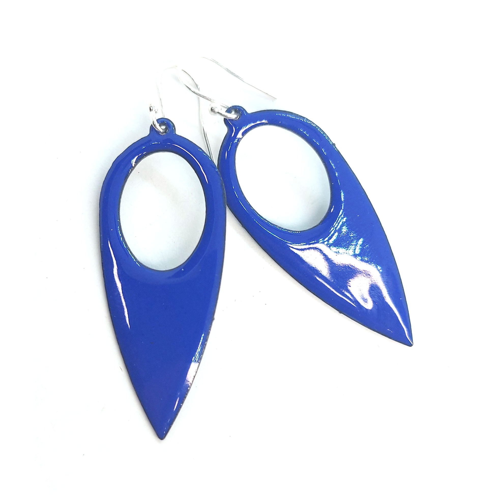 Large teardrop-shaped dark blue enamel drop earrings with a cut out circle.