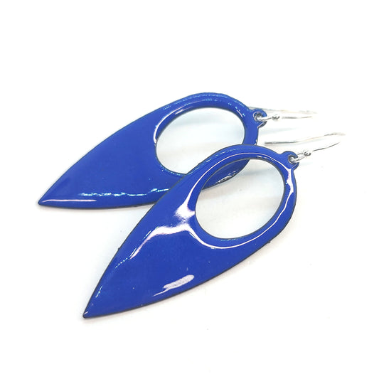 Large teardrop-shaped dark blue enamel drop earrings with a cut out circle.