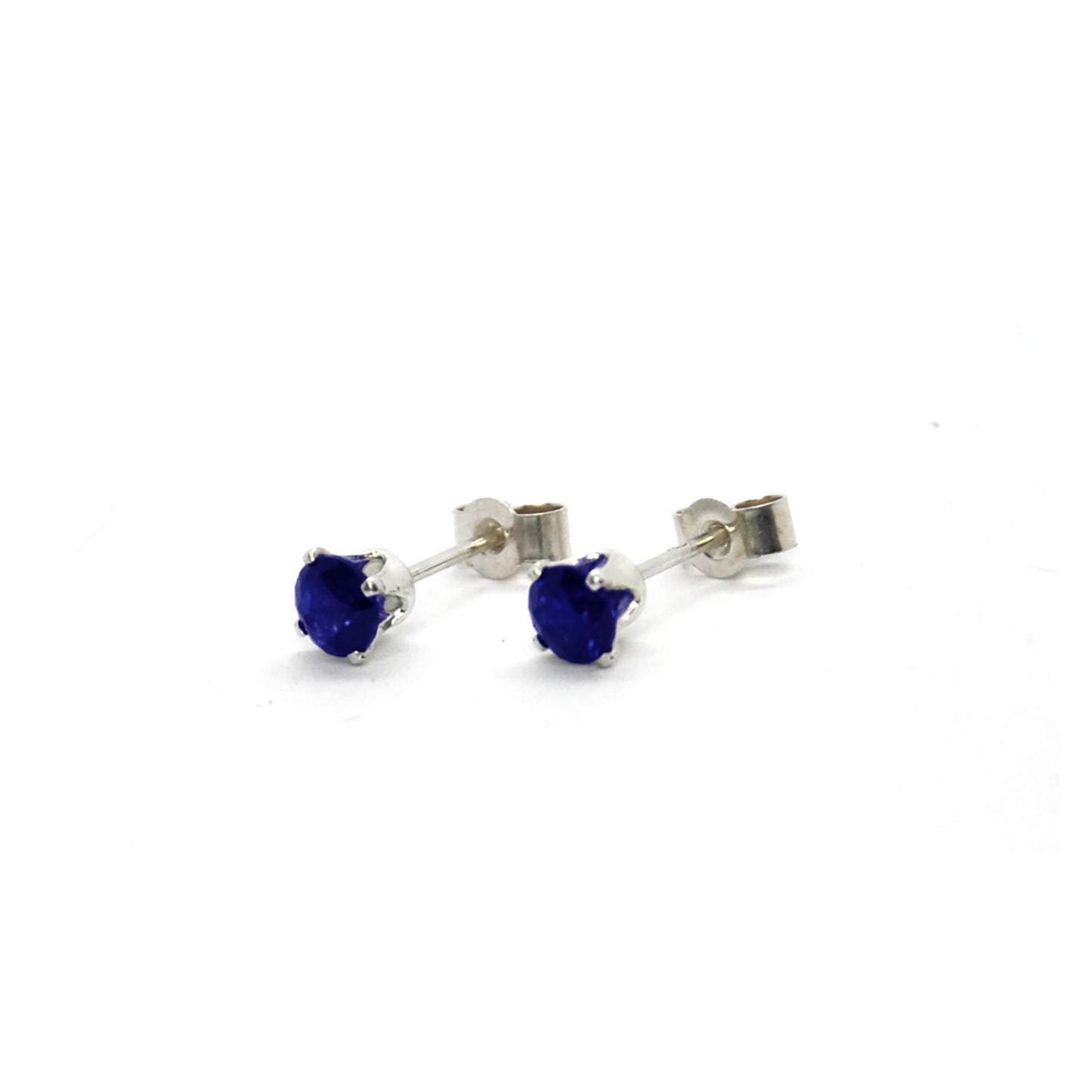 Silver 4 claw stud earrings set with dark blue sapphires. 4mm