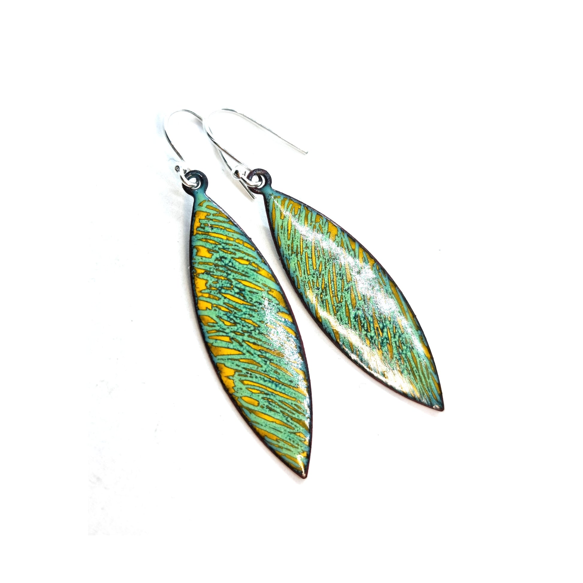 Boat shaped drop earrings with a rustic line pattern of light green and yellow enamel. With silver ear hooks.