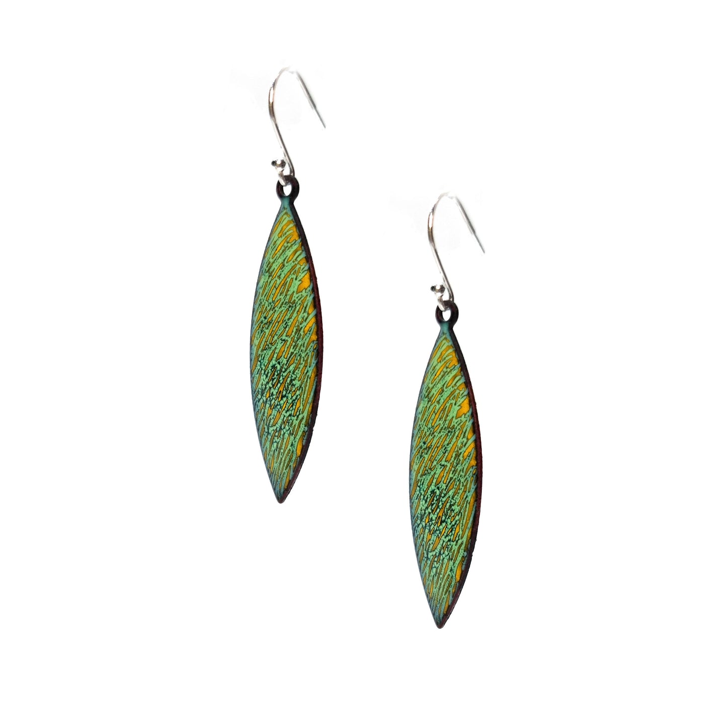 Boat shaped drop earrings with a rustic line pattern of light green and yellow enamel. With silver ear hooks. Side view.