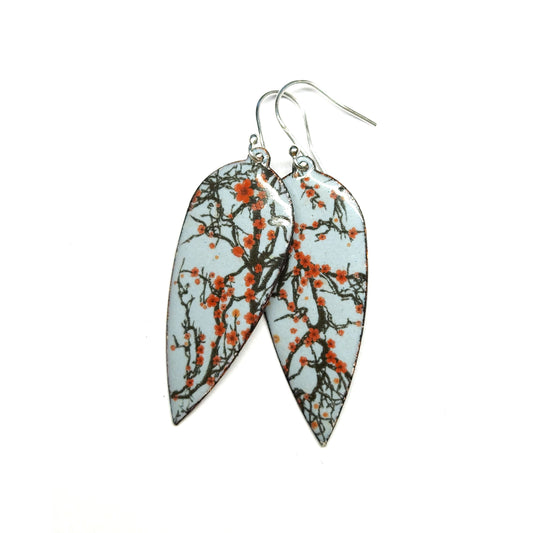 Statement enamel earrings featuring branches and red cherry blossom. On silver ear hooks.