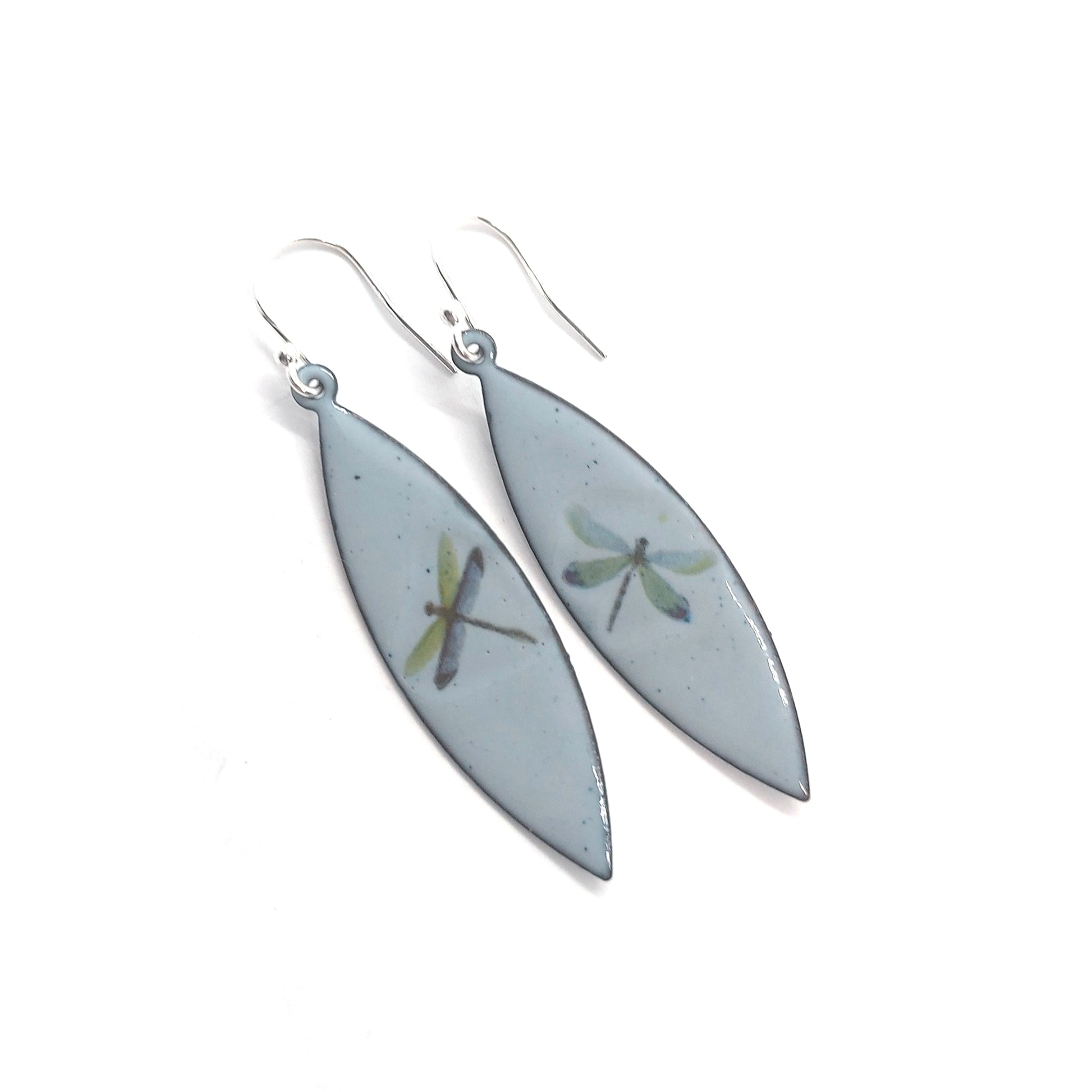 Boat shaped drop earrings with grey enamel. Each earring features one dragonfly in various colours. On silver ear hooks.