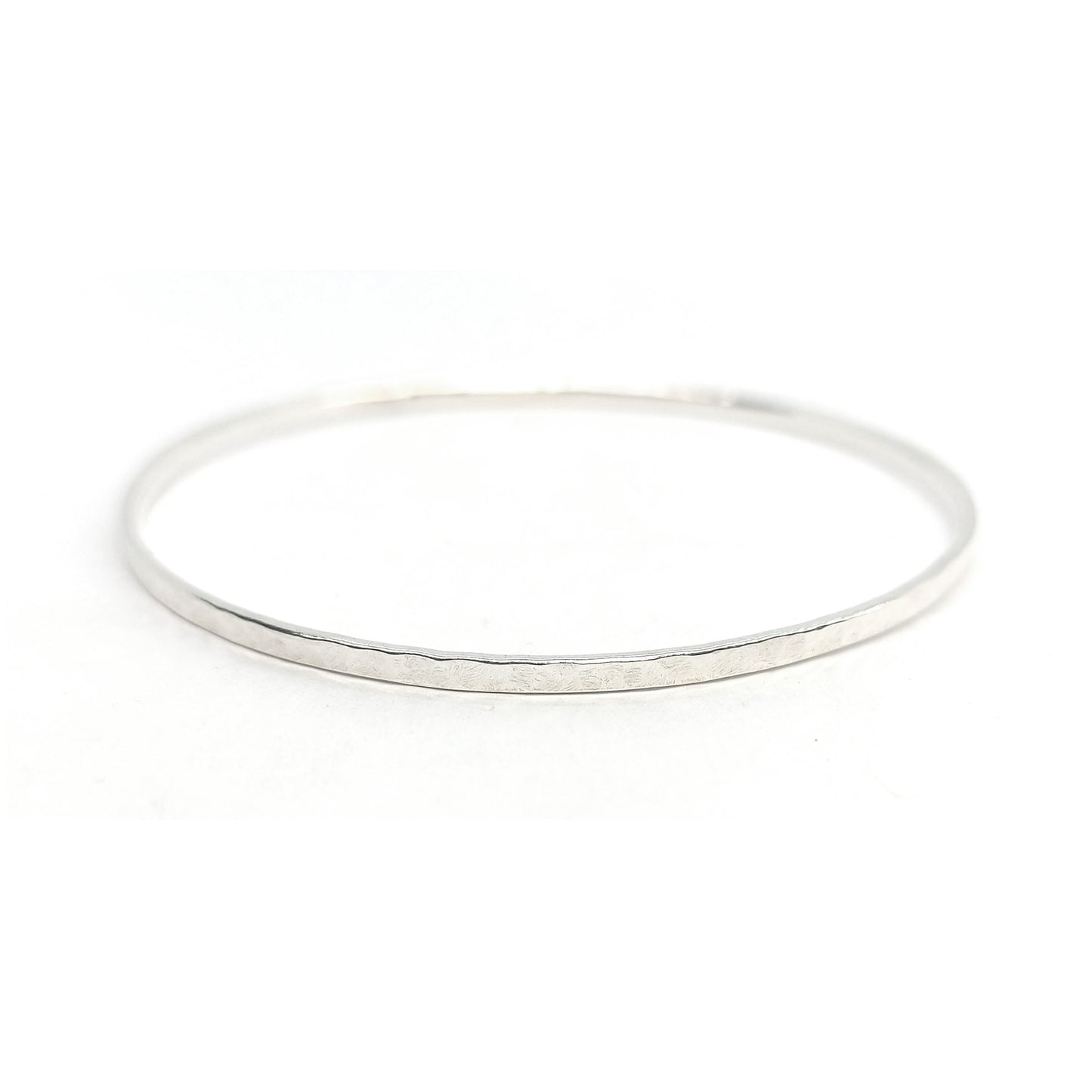 Thin silver hammered stacking slave bangle.