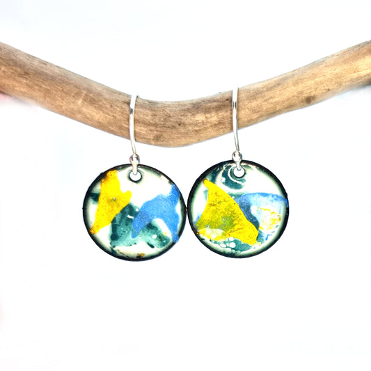 Round enamel drop earrings with splashes of blue, green and yellow on a white background.