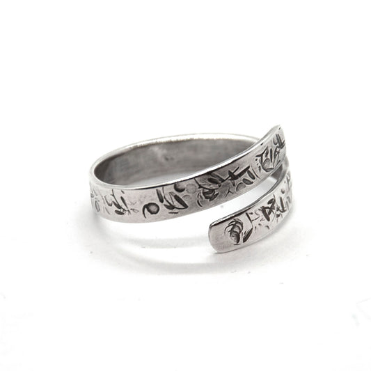 A flat silver wrap ring with leaf, bed and stalk pattern.