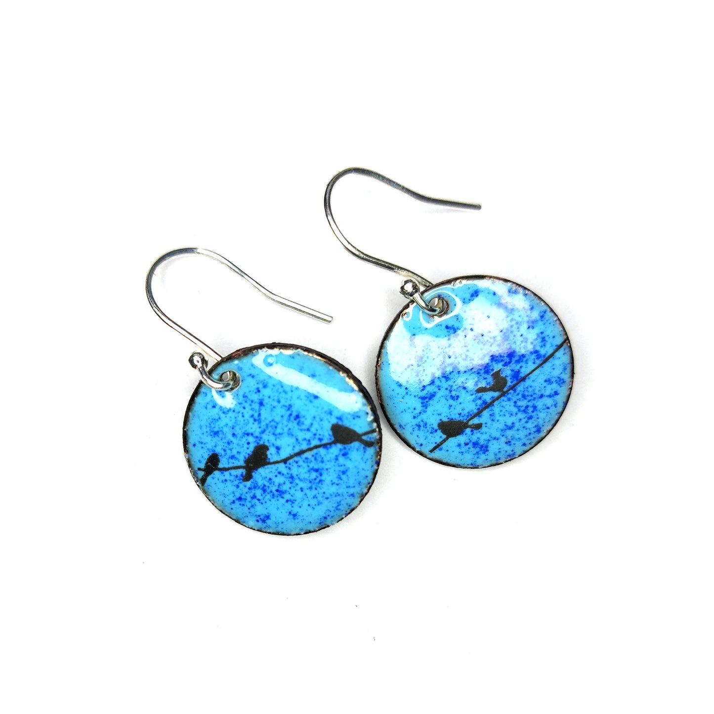 Round enamel drop earrings with blue background and black silhouettes of birds sitting on a wire.