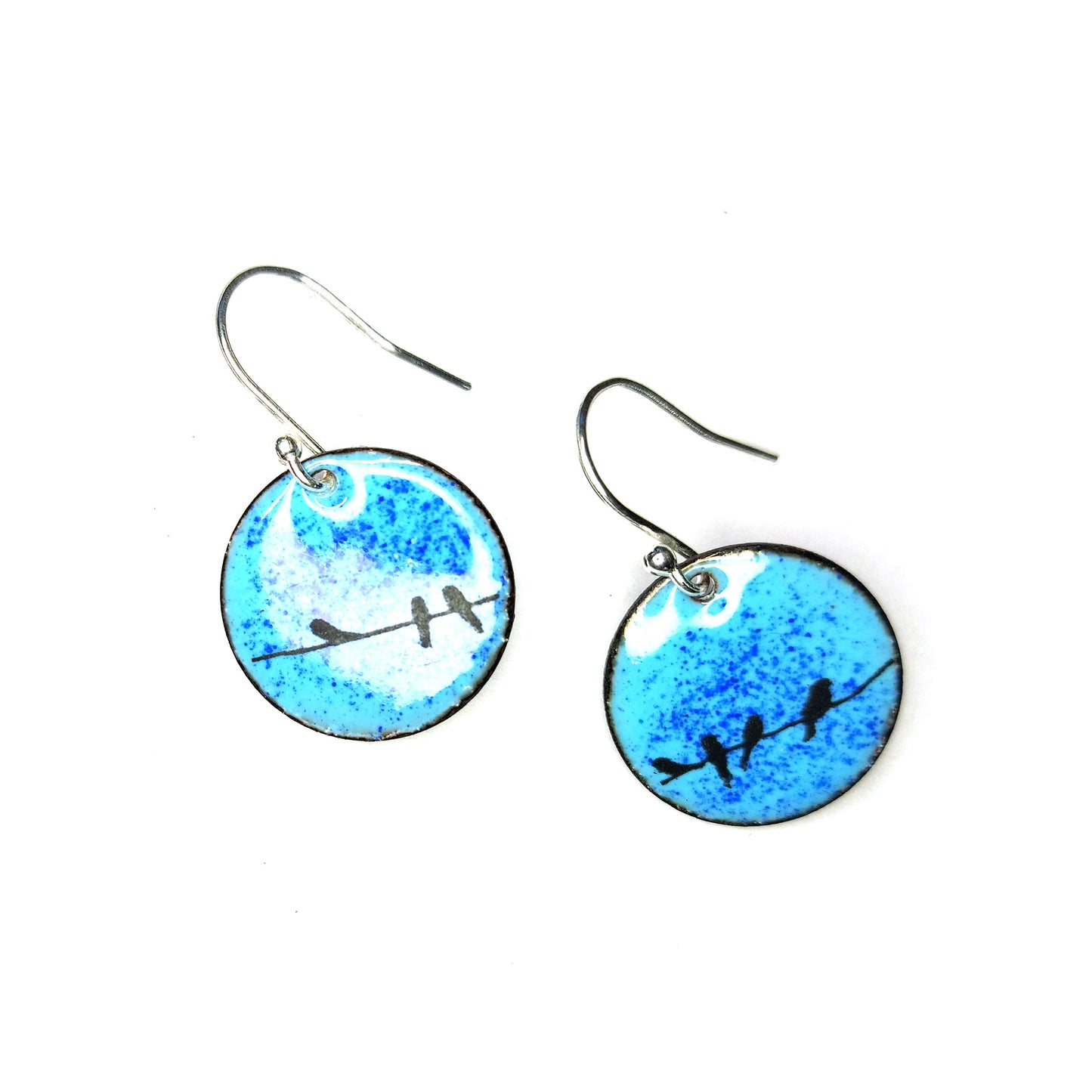 Round enamel drop earrings with blue background and black silhouettes of birds sitting on a wire.