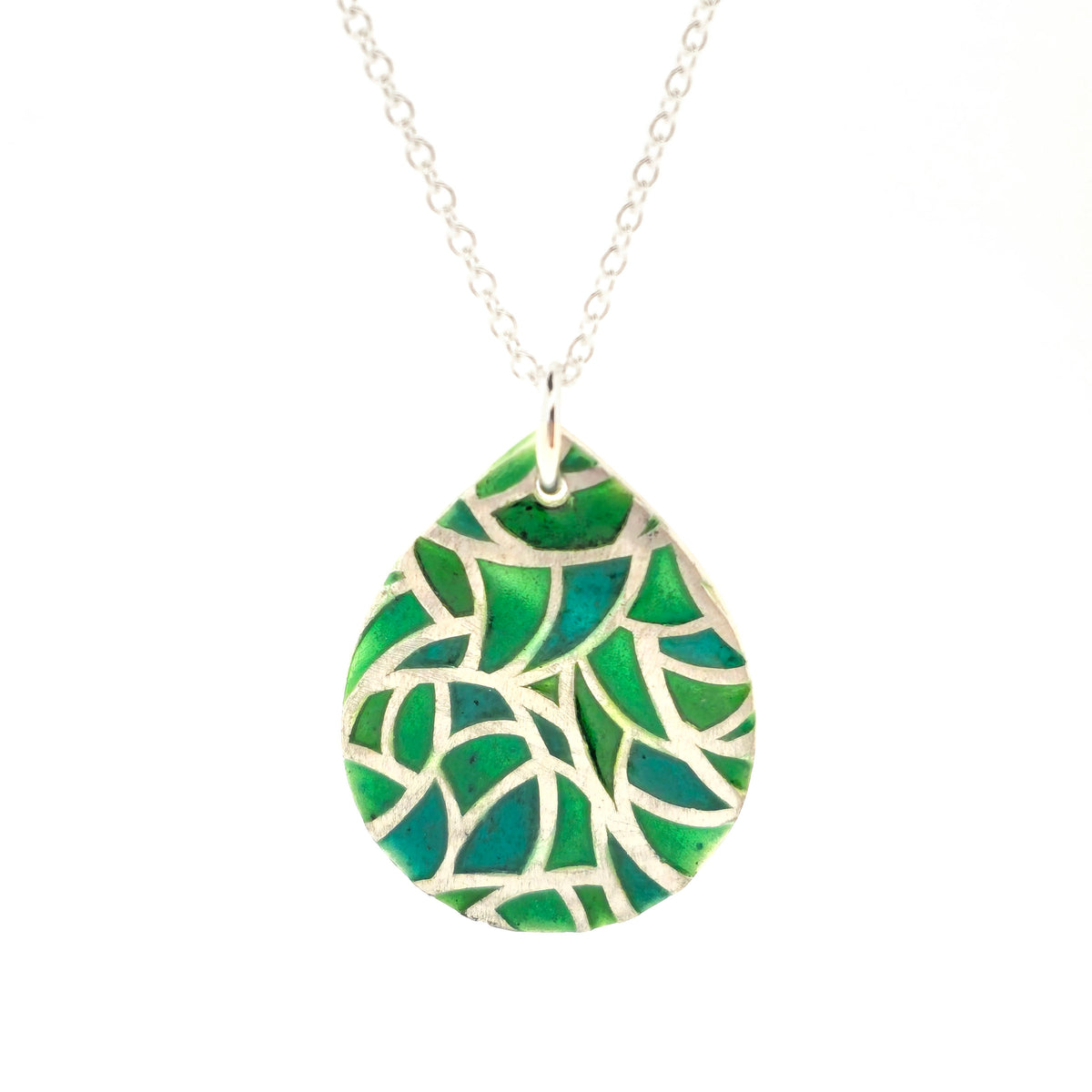 A handmade teardrop-shaped pendant necklace featuring a green enamel mosaic pattern with a silver chain, shown against a plain white background. Mijoux Jewellery.