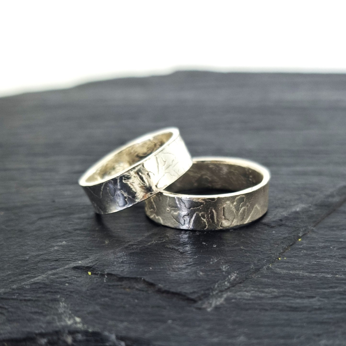 Two silver band rings with islands in the sea style pattern. His and hers.