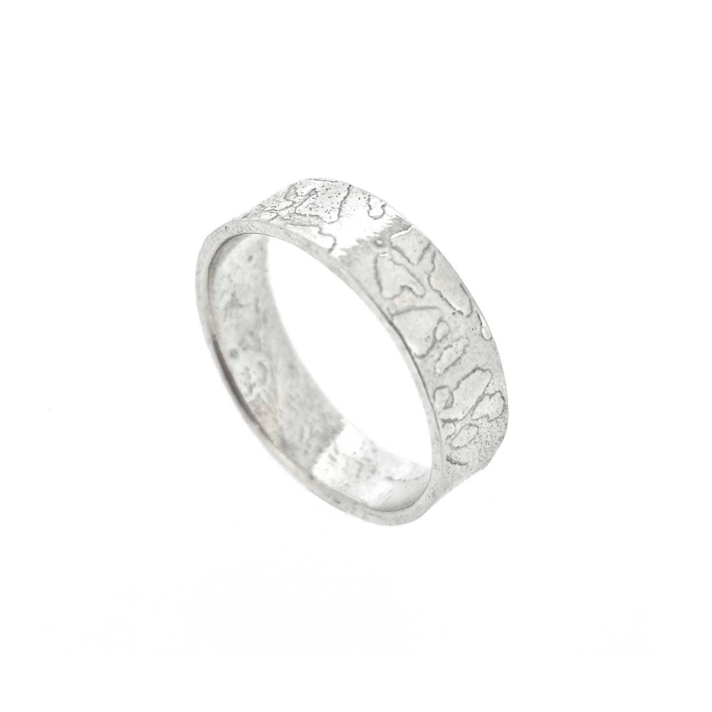 Silver band ring with islands in the sea style pattern.