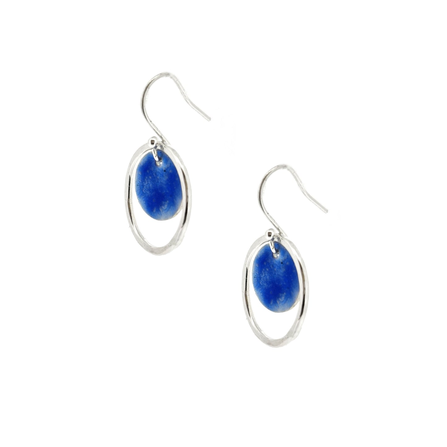 Silver drop earrings with a central disc featuring patterned dark blue enamel surrounded by a silver hammered open circle.