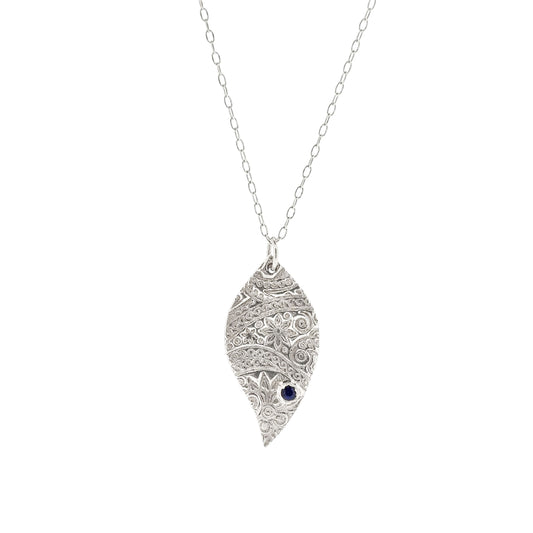 Silver asymmetrical patterned pendant with blue gemstone on chain