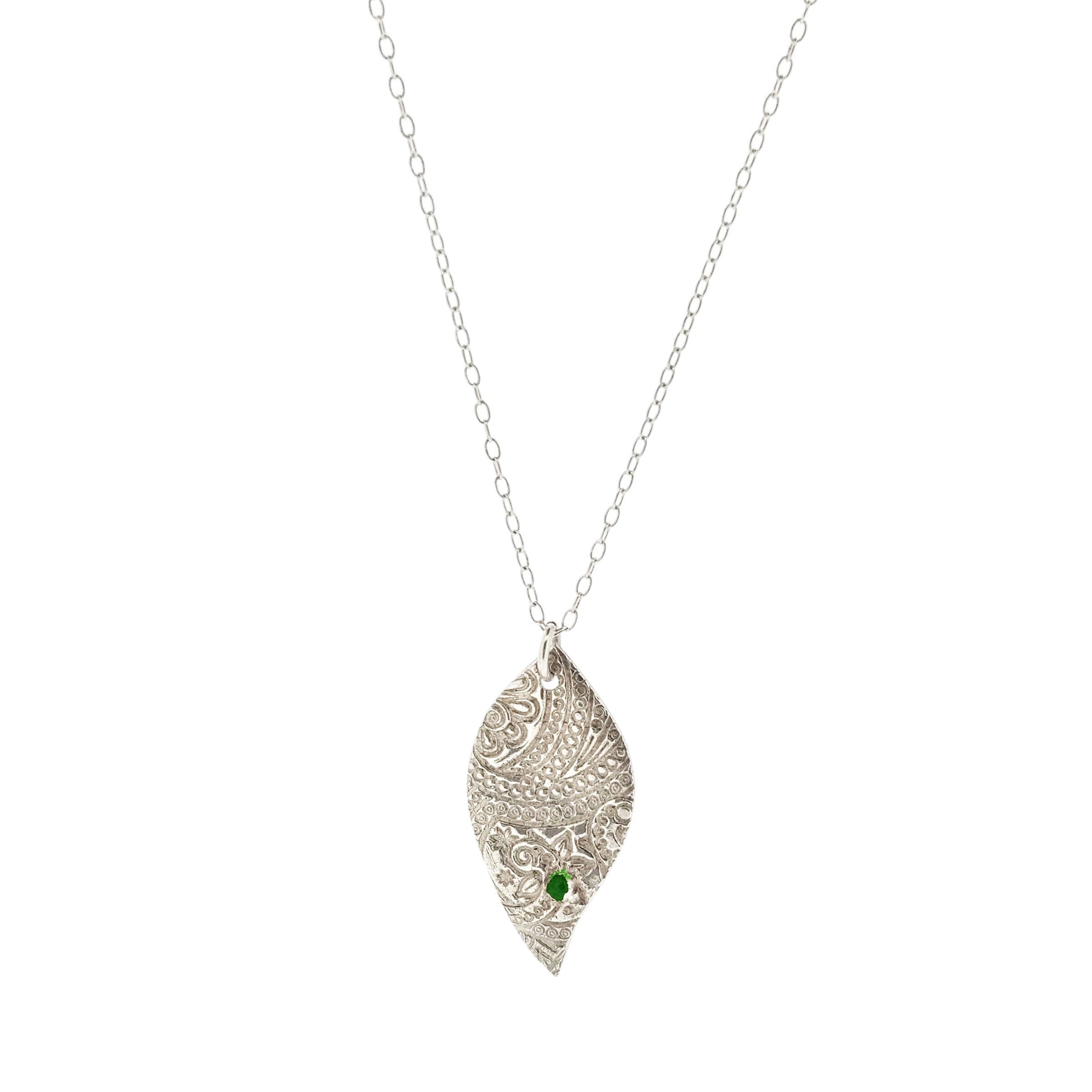 Silver asymmetrical patterned pendant with green gemstone on chain