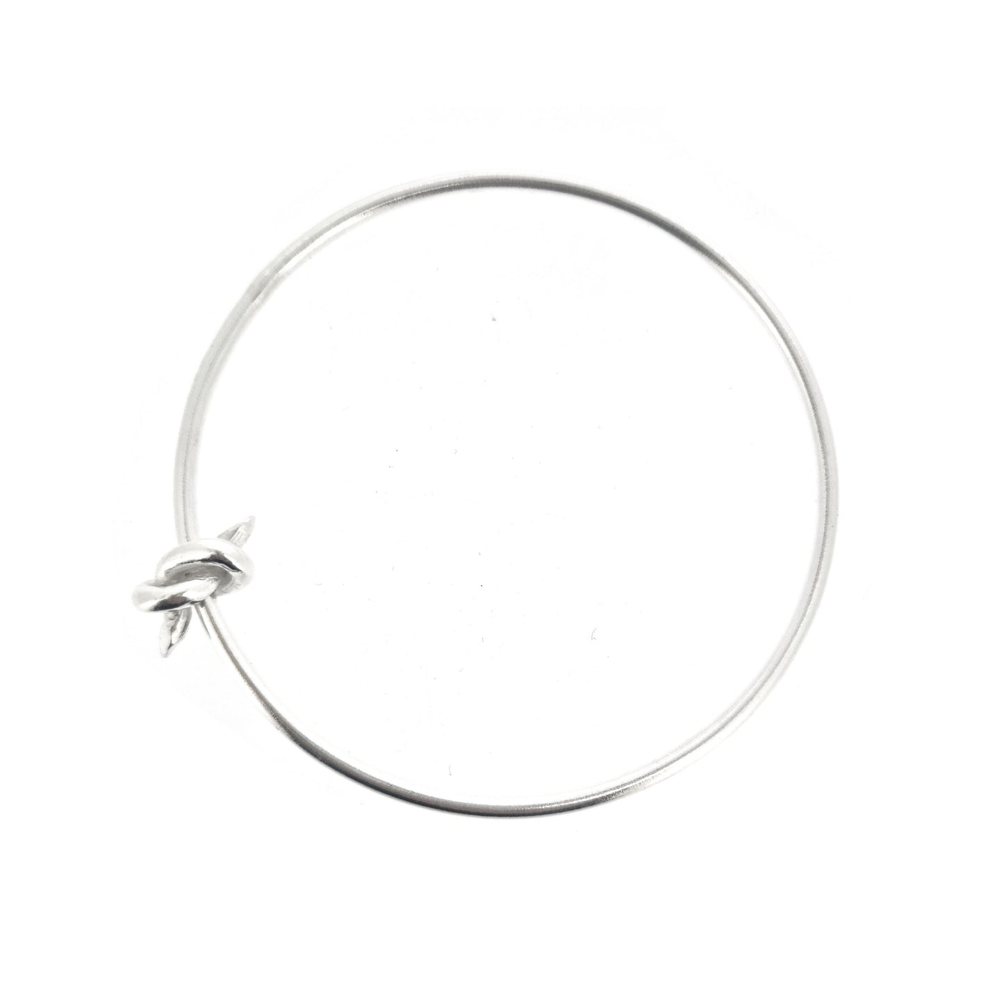 Silver round bangle with spinning knot charm.