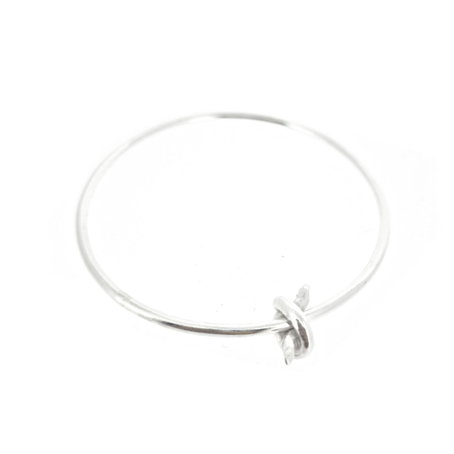 Silver round bangle with spinning knot charm.